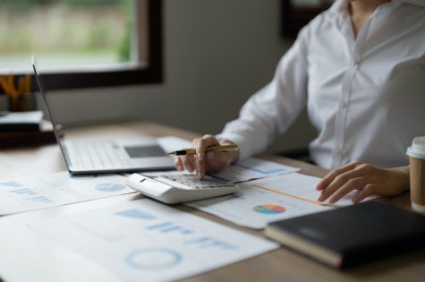 Business woman using calculator for do math finance in office, tax, accounting, statistics and