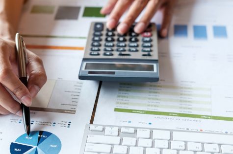 Close up accountant or financial expert analyze business report graph and finance chart at corporate